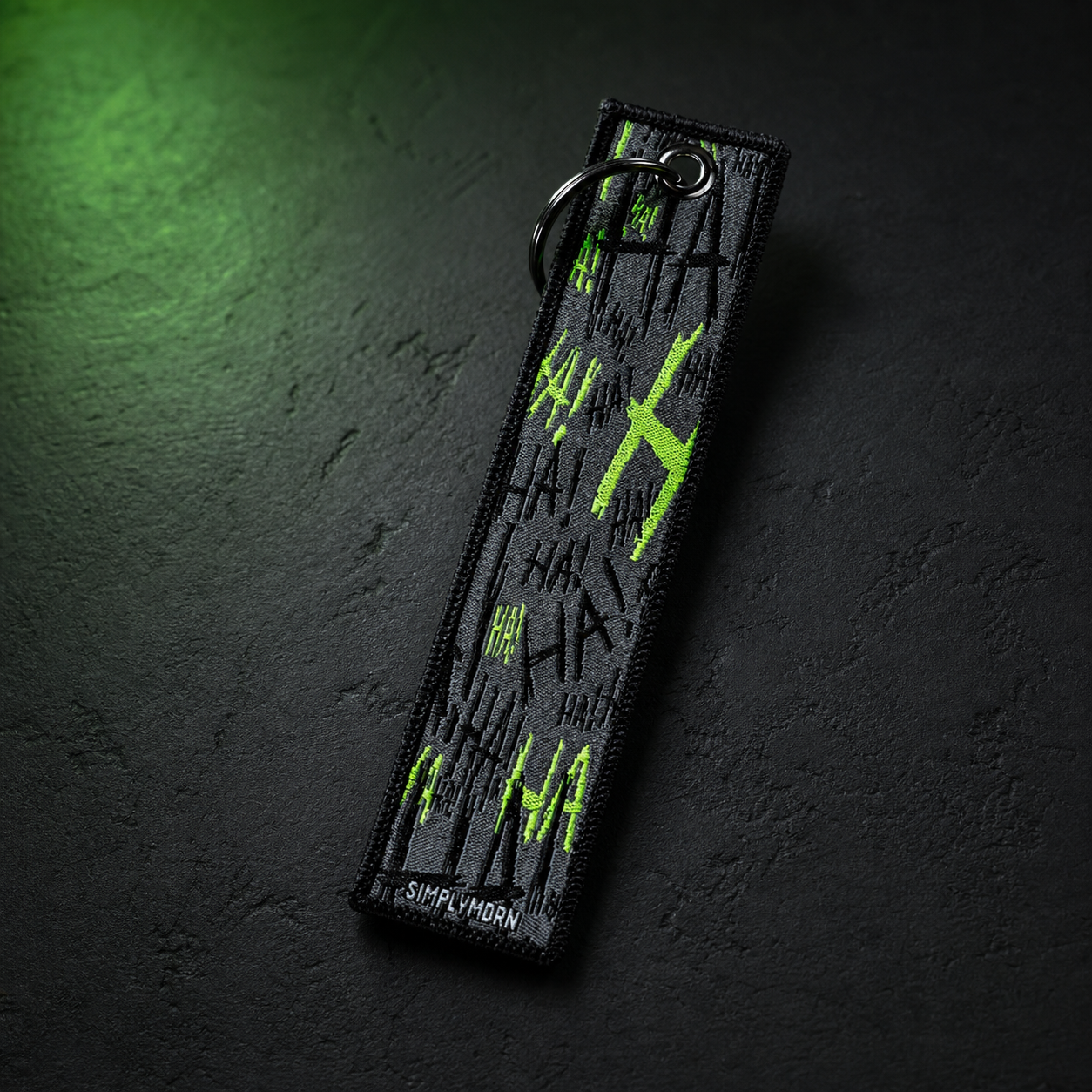 JOK3STER black and neon green embroidered keychain dark studio view