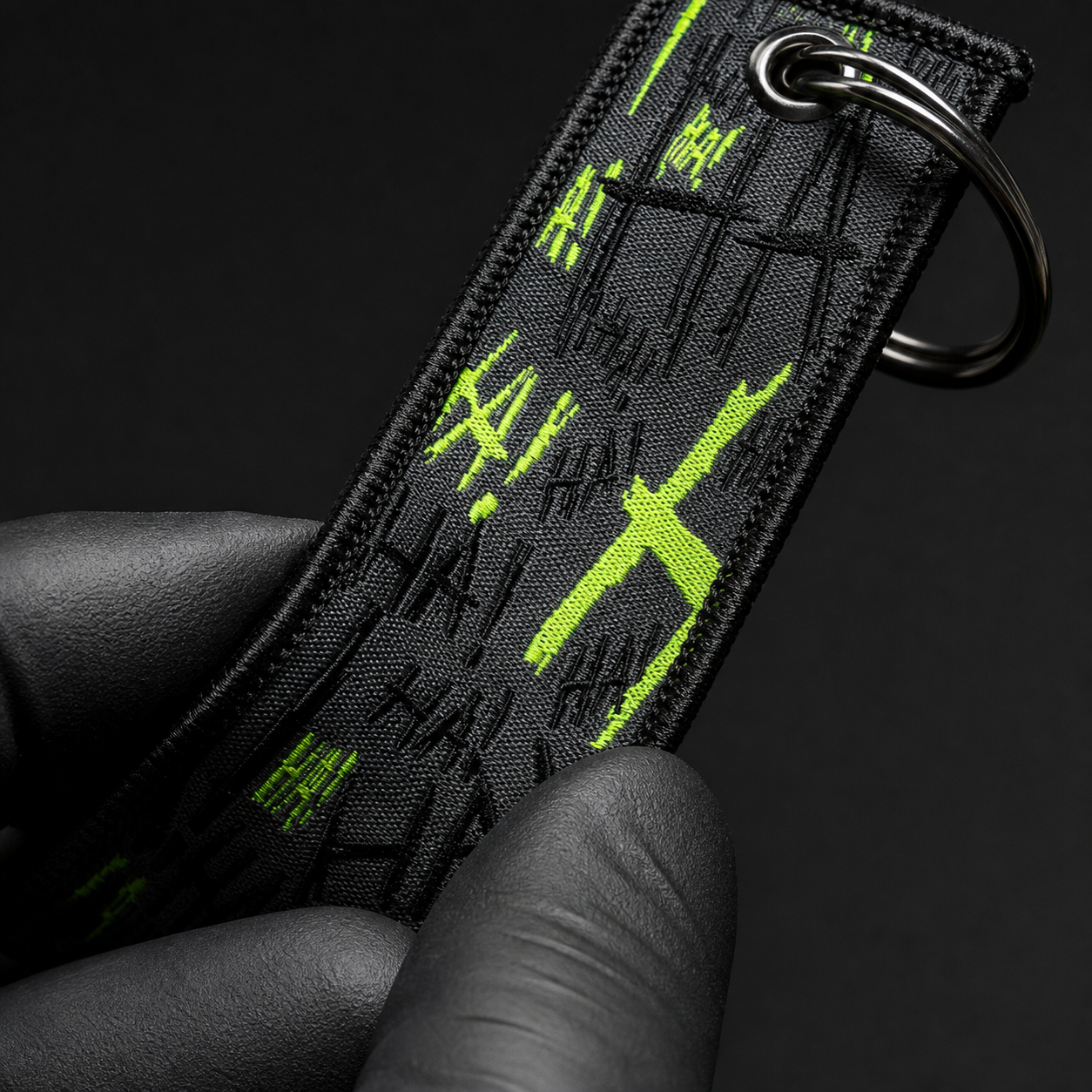 Close view of embroidered keychain stitching and metal split-ring hardware